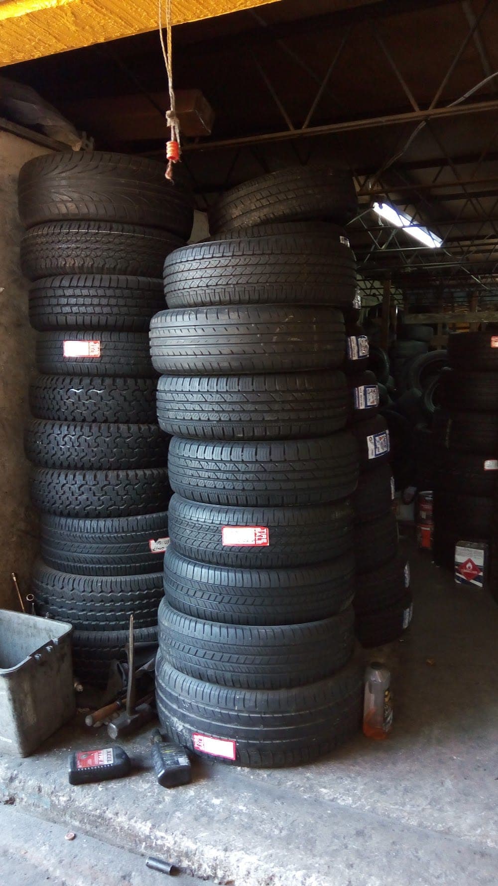 Stacks of new and quality-used tires inside George's Tires, sorted by size