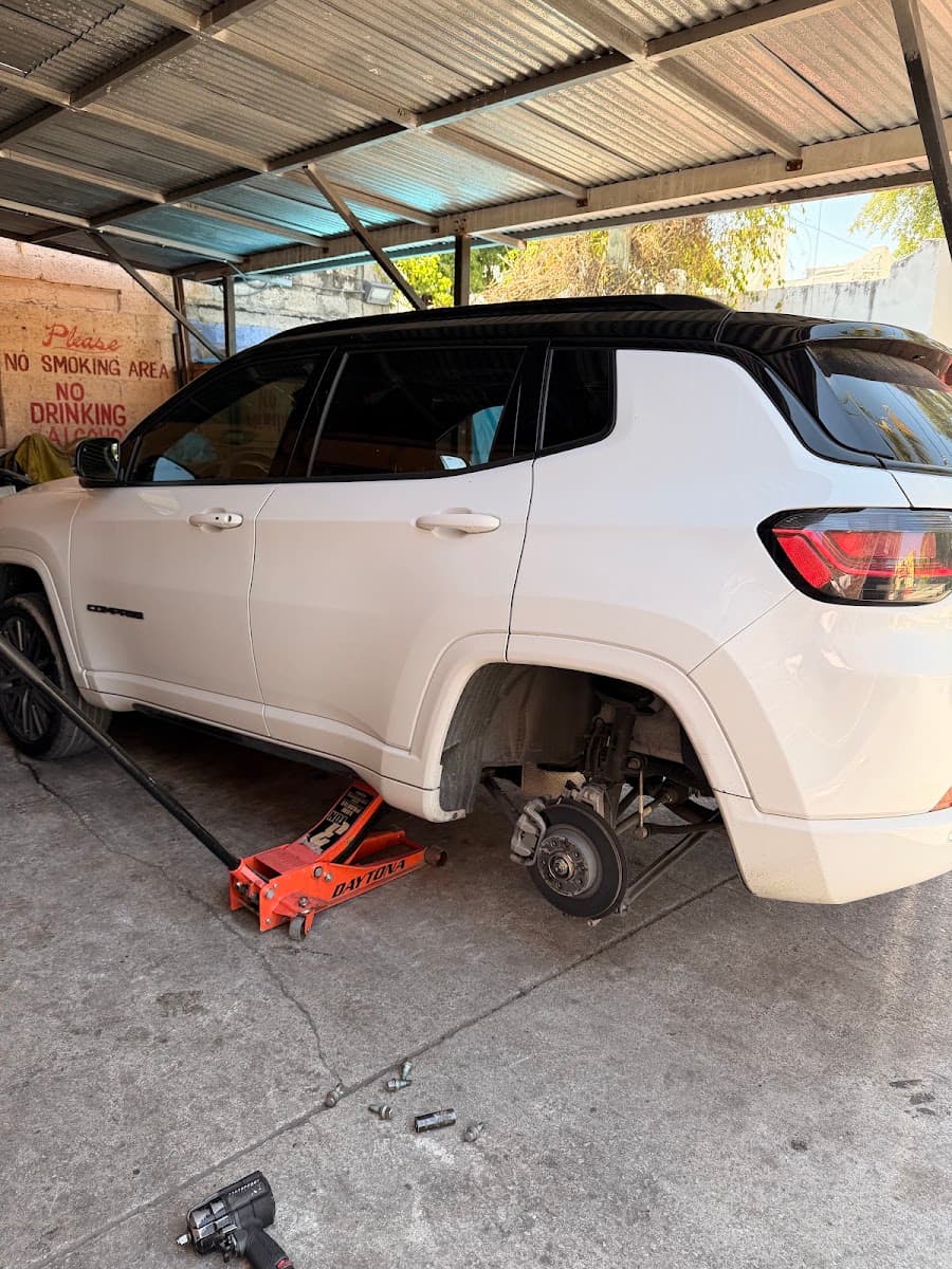 SUV with a wheel removed during a tire service at George's Tires